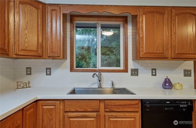 kitchen featuring decorative backsplash, black dishwasher, and sink