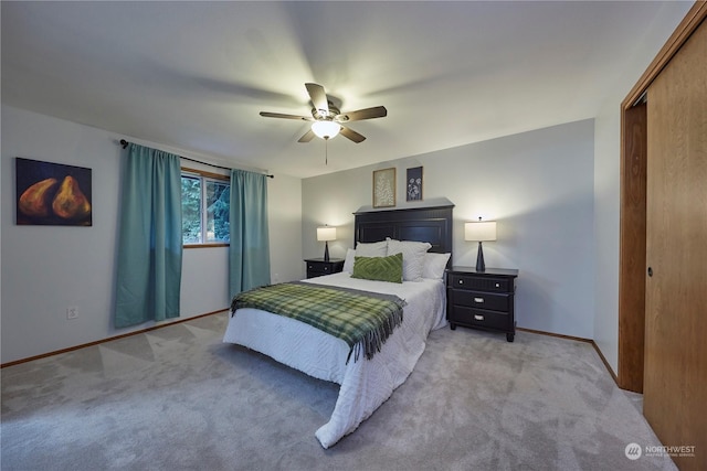 bedroom featuring ceiling fan, a closet, and carpet floors