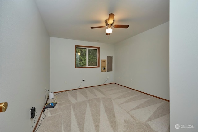 carpeted empty room with electric panel and ceiling fan