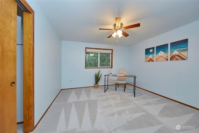 home office featuring ceiling fan and light carpet