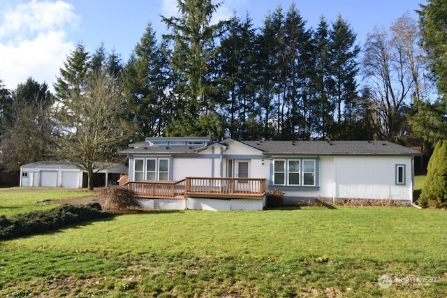 rear view of house featuring a lawn and a wooden deck