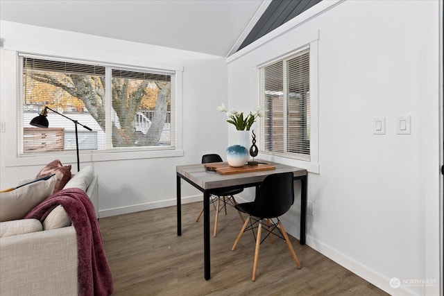 home office with dark hardwood / wood-style flooring and lofted ceiling