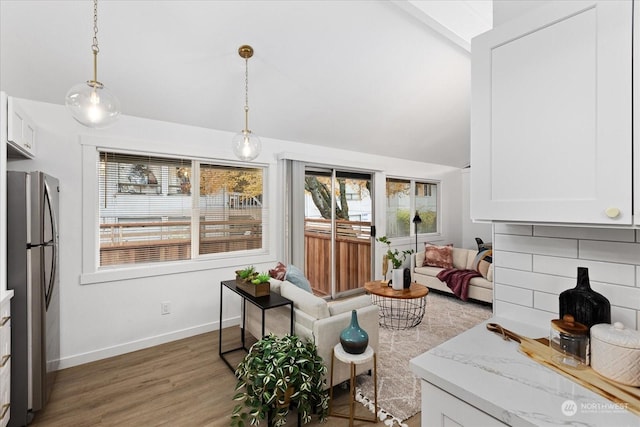 living room featuring dark wood-type flooring and vaulted ceiling