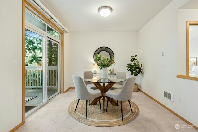 dining room with light colored carpet