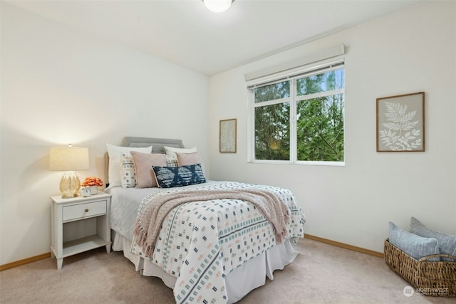 bedroom featuring light colored carpet