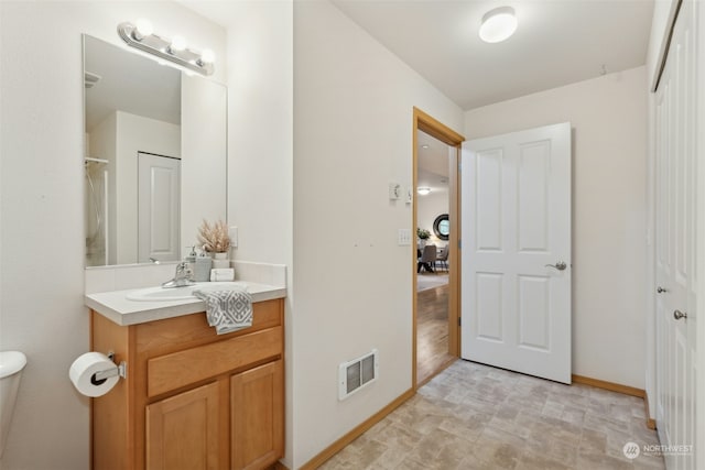 bathroom featuring vanity and toilet