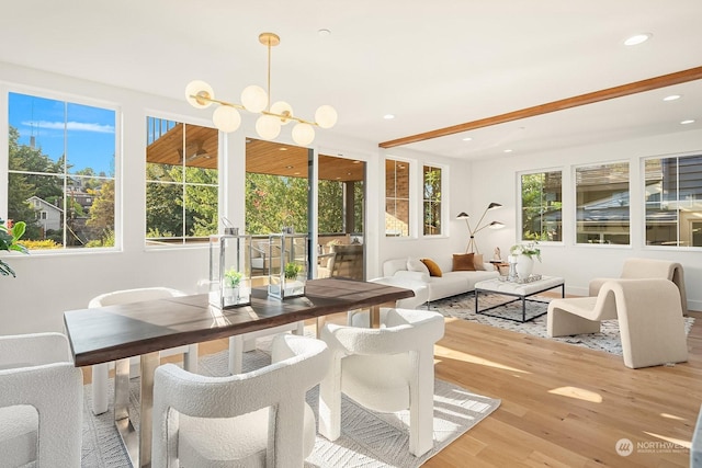 sunroom featuring a notable chandelier