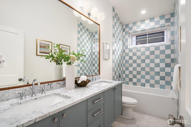 full bathroom featuring toilet, tile patterned floors, vanity, and tiled shower / bath combo