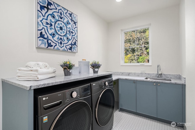 clothes washing area featuring light tile patterned flooring, cabinets, separate washer and dryer, and sink