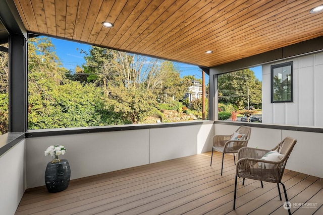 sunroom / solarium with plenty of natural light and wood ceiling