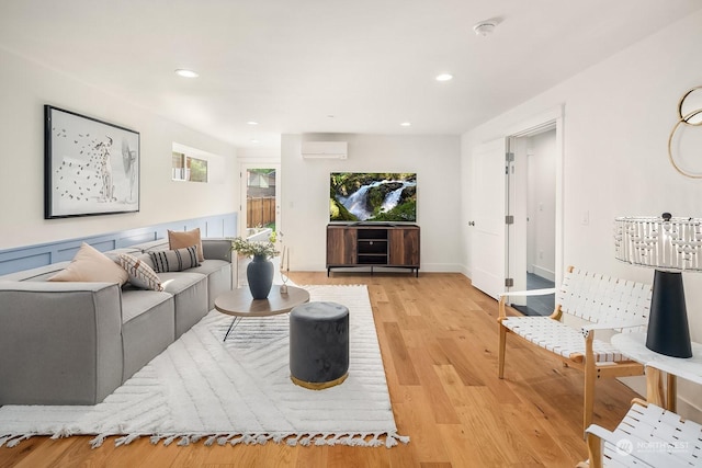 living room with light wood-type flooring and a wall mounted AC