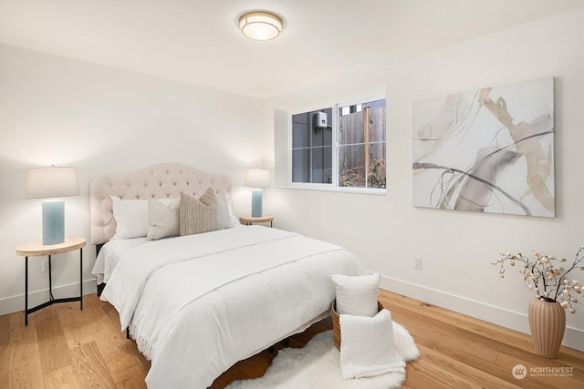 bedroom with wood-type flooring