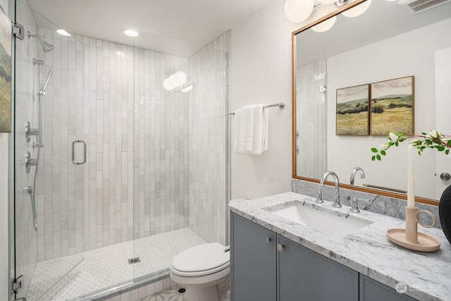 bathroom with vanity, toilet, and walk in shower