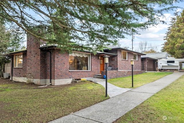 view of front of house featuring a garage, central AC unit, and a front lawn