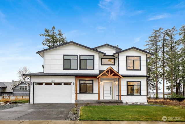 view of front facade featuring a front yard and a garage