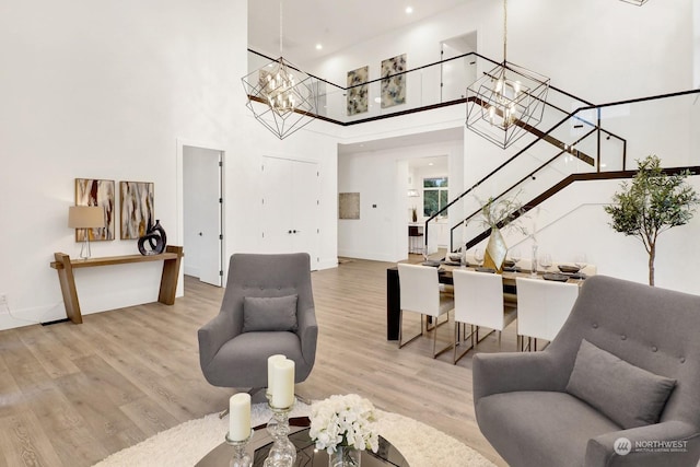 living room with a high ceiling and light hardwood / wood-style flooring