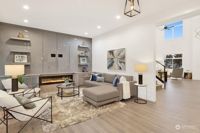 living room featuring ceiling fan and light wood-type flooring