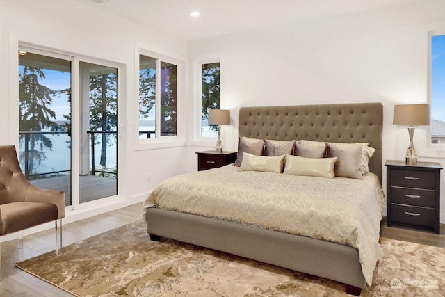 bedroom with hardwood / wood-style floors and access to exterior