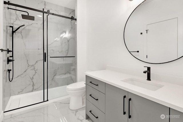 bathroom with vanity, toilet, and a shower with door