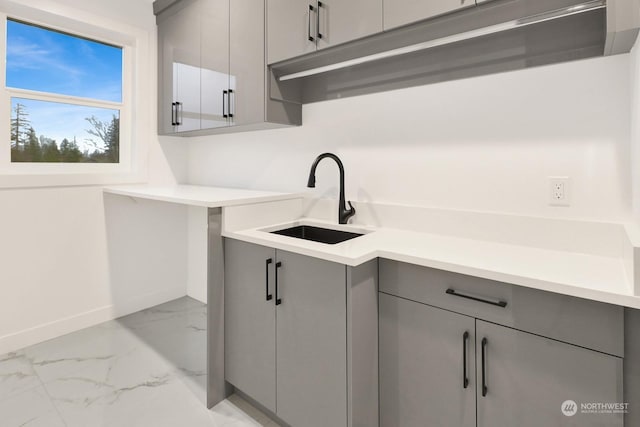 kitchen featuring gray cabinetry and sink