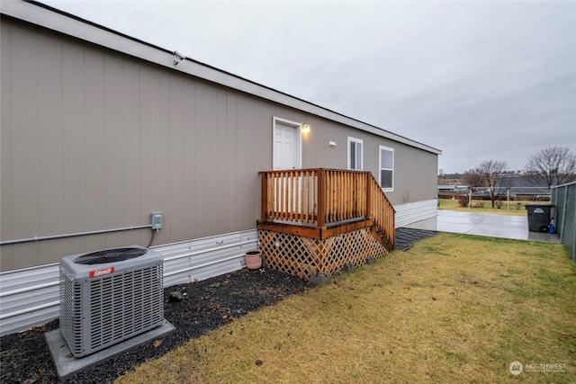 exterior space featuring central AC unit and a lawn