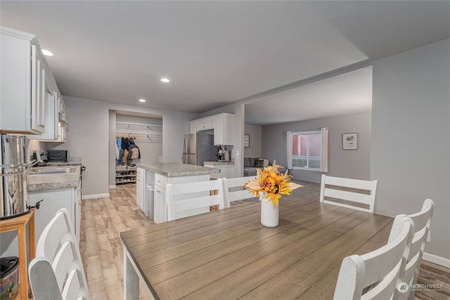 dining area featuring light wood-type flooring