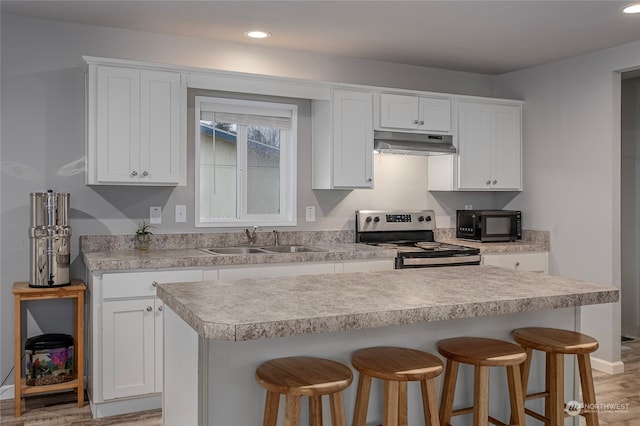 kitchen with sink, white cabinetry, stainless steel electric stove, and light hardwood / wood-style floors