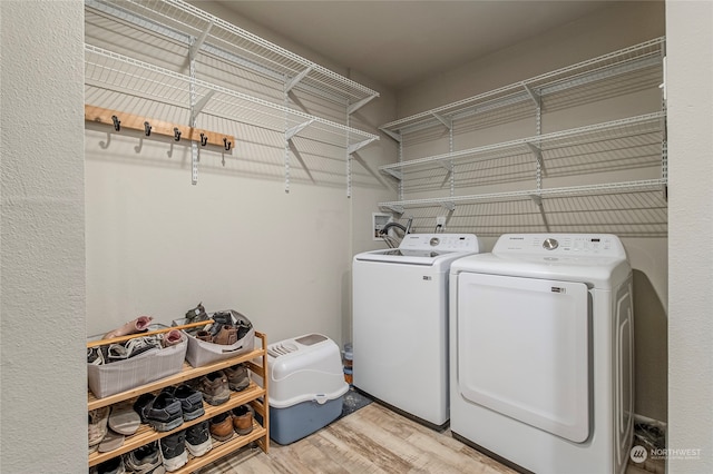 washroom featuring washer and dryer and light wood-type flooring