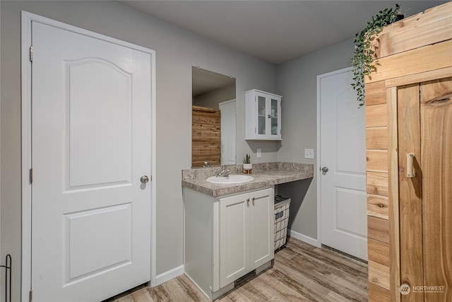 bathroom with hardwood / wood-style floors and vanity