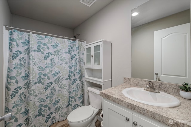 bathroom featuring toilet and vanity