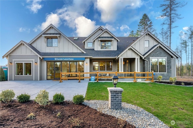 rear view of house featuring a yard