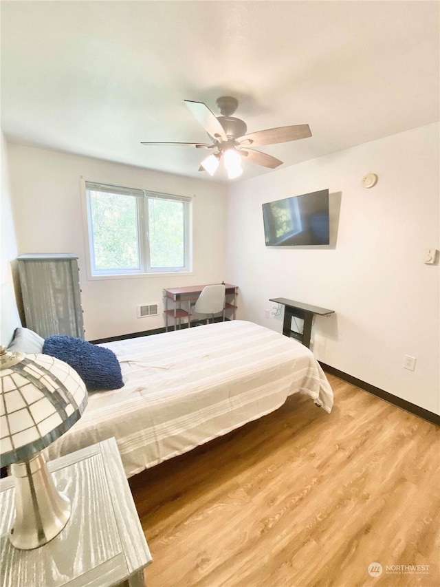 bedroom with hardwood / wood-style flooring and ceiling fan