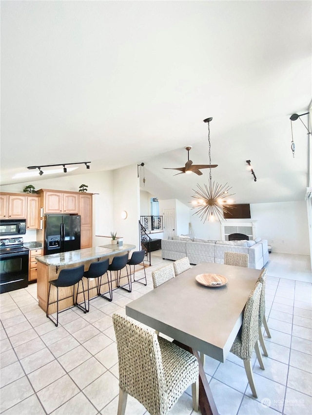 dining space featuring ceiling fan and light tile patterned flooring