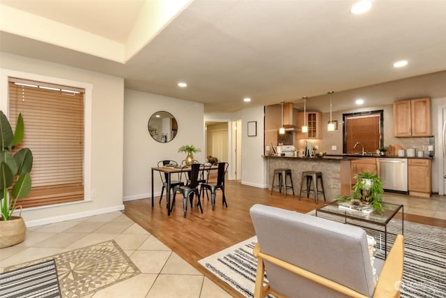 living room featuring light tile patterned floors and sink