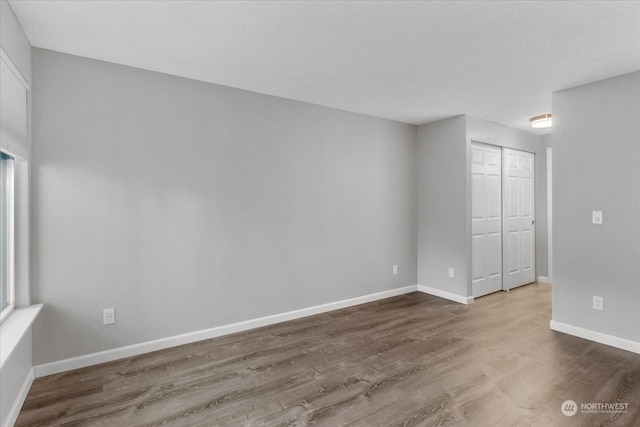 spare room with hardwood / wood-style flooring