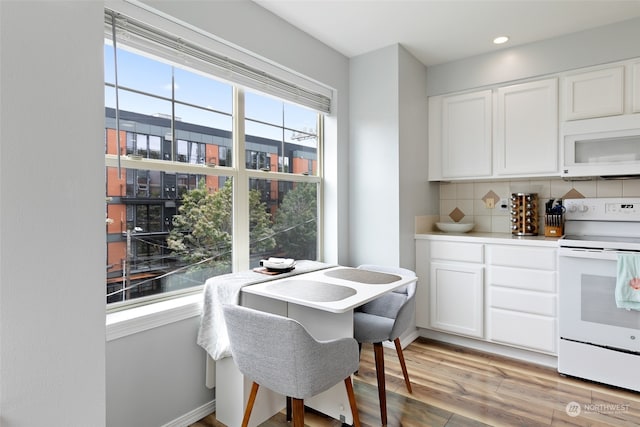 dining room featuring light wood-type flooring and a wealth of natural light