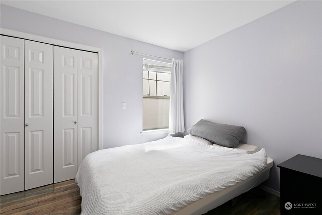 bedroom featuring a closet and dark hardwood / wood-style flooring