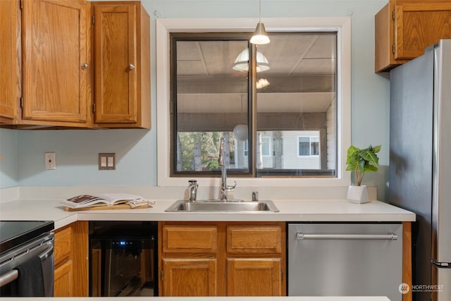 kitchen with hanging light fixtures, beverage cooler, sink, and appliances with stainless steel finishes