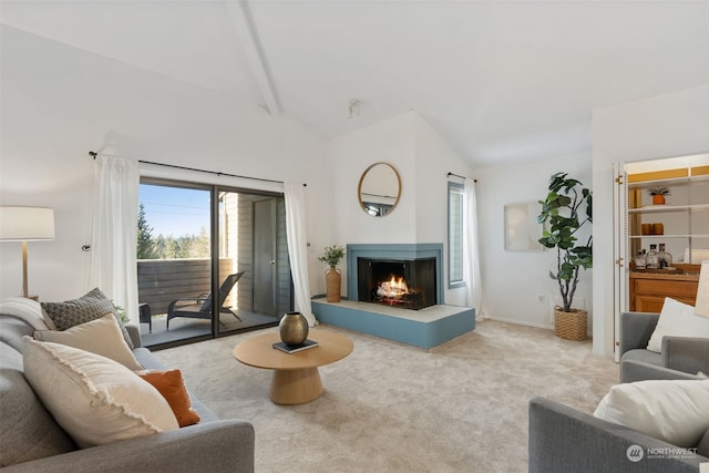 carpeted living room featuring a multi sided fireplace and vaulted ceiling with beams