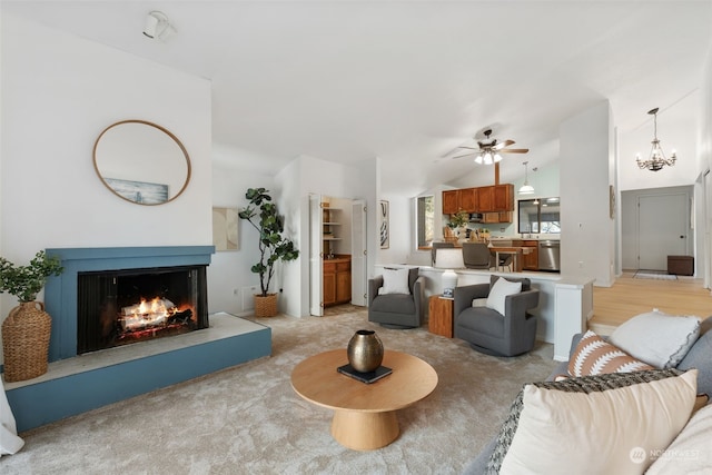 living room featuring ceiling fan with notable chandelier and vaulted ceiling