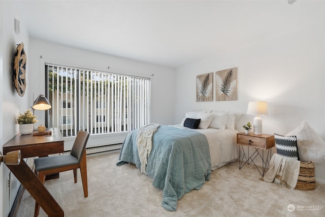 bedroom with a baseboard heating unit, light carpet, and multiple windows