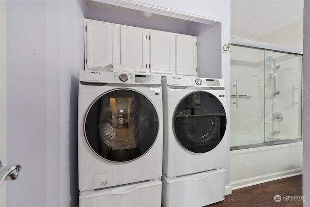 washroom featuring washing machine and clothes dryer and dark wood-type flooring