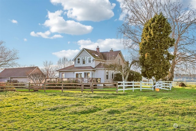 rear view of house featuring a yard