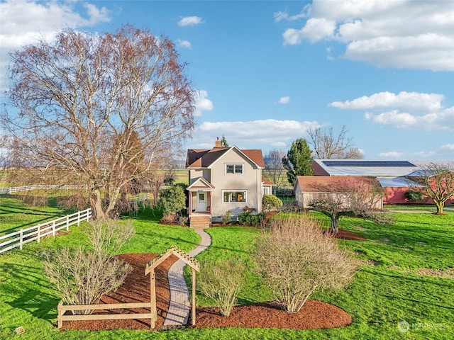 view of front facade featuring a rural view and a front lawn