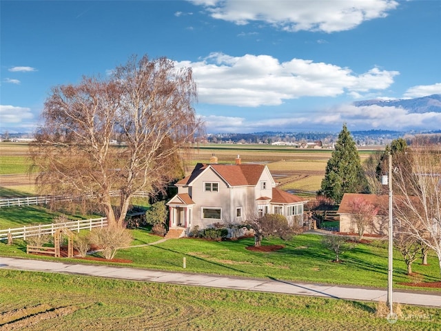 view of front of home featuring a rural view and a front yard