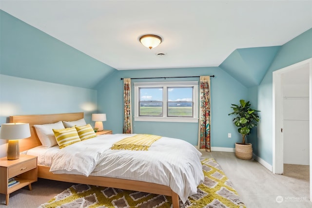 bedroom with carpet floors and vaulted ceiling