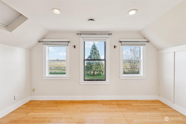 additional living space featuring light hardwood / wood-style floors and lofted ceiling