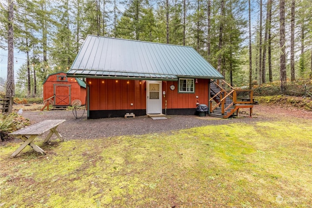 exterior space featuring a shed and a front lawn