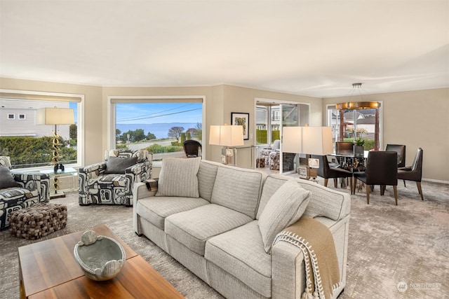 living room featuring carpet flooring and a chandelier