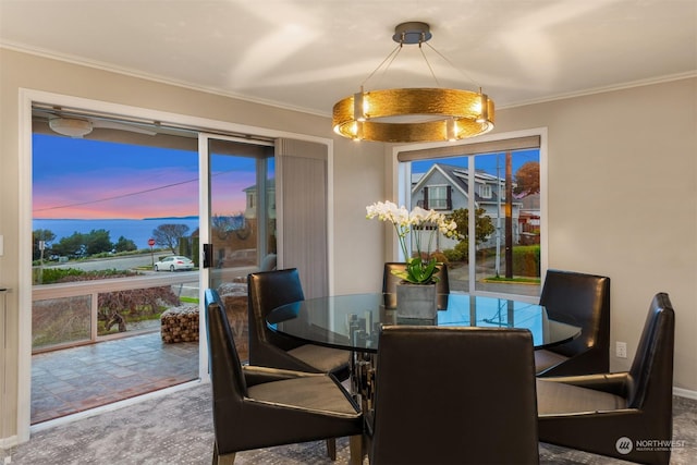 dining space with crown molding